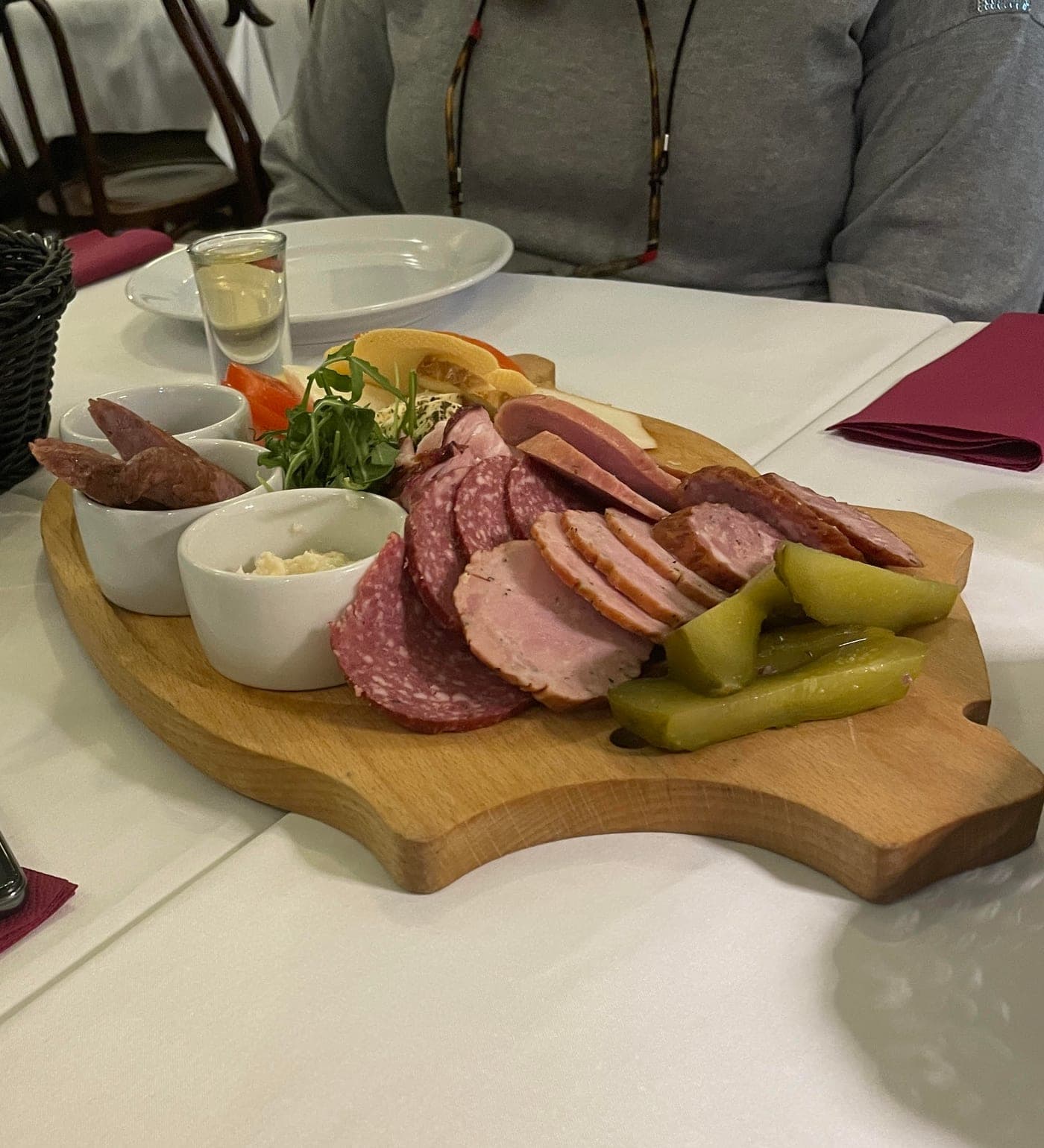Traditional Polish charcuterie spread with bread, pickles and herring