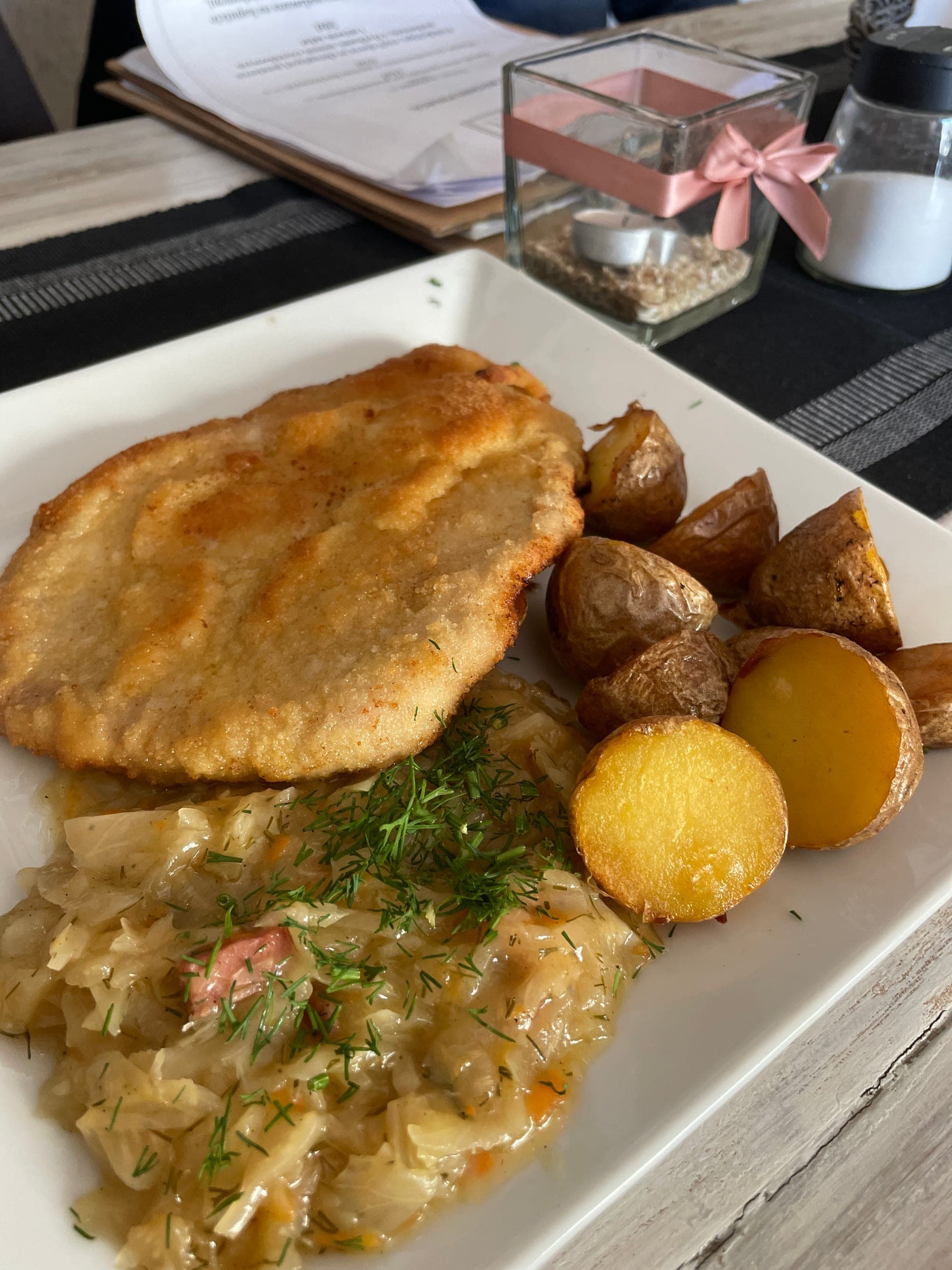 A milk bar plate of schabowy, roasted potatoes and braised cabbage