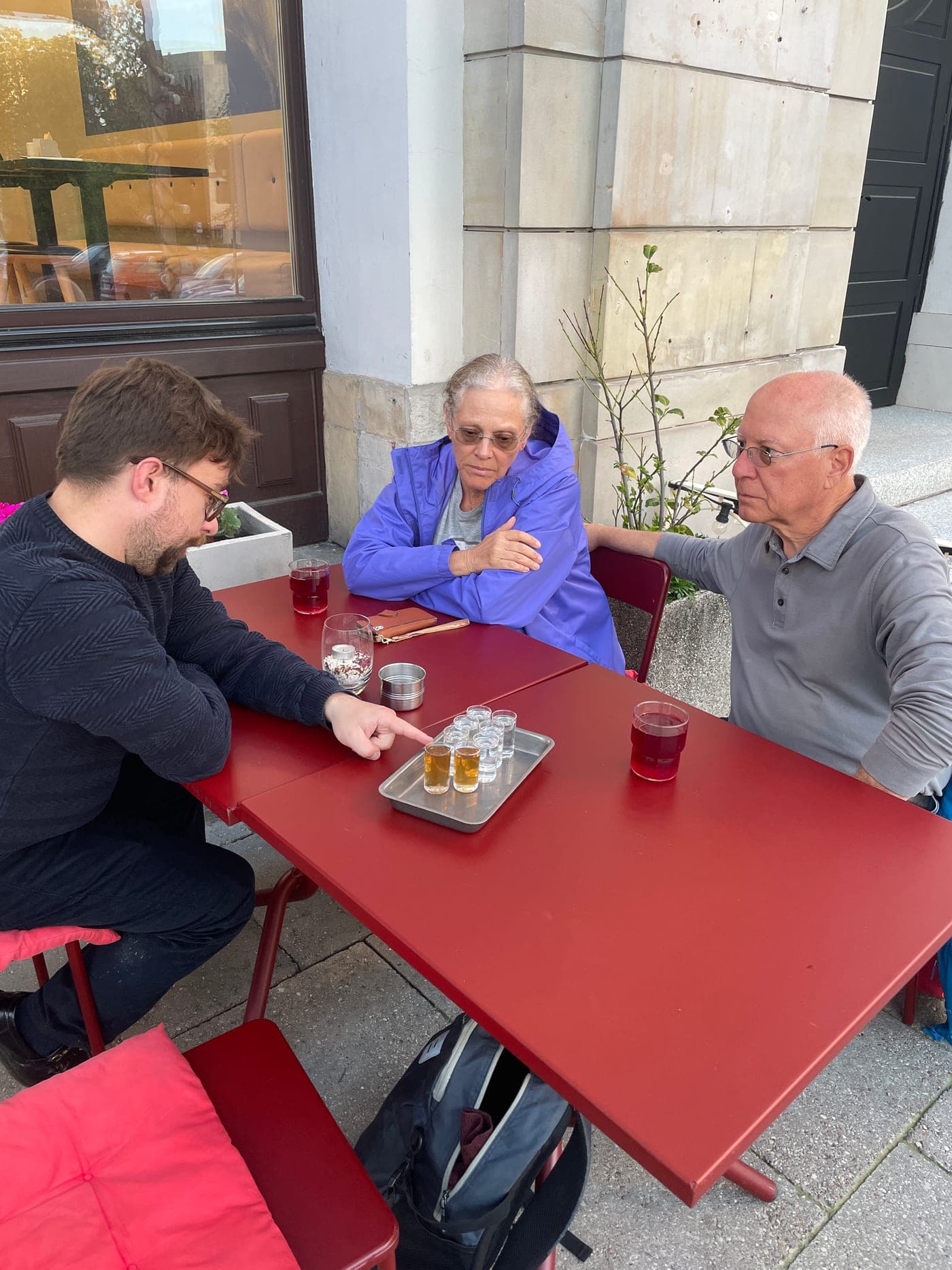 Tasty Trails guide walking guests through a Polish vodka tasting flight at an outdoor table in Warsaw