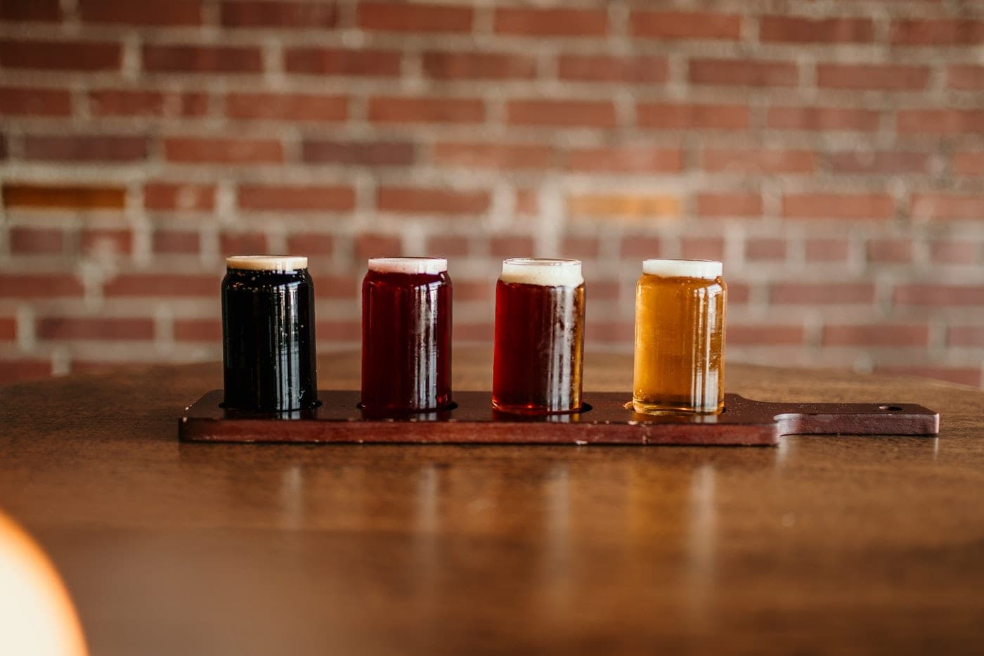 Craft beer tasting glasses lined up at an independent Warsaw brewery on the Craft Beer Tour