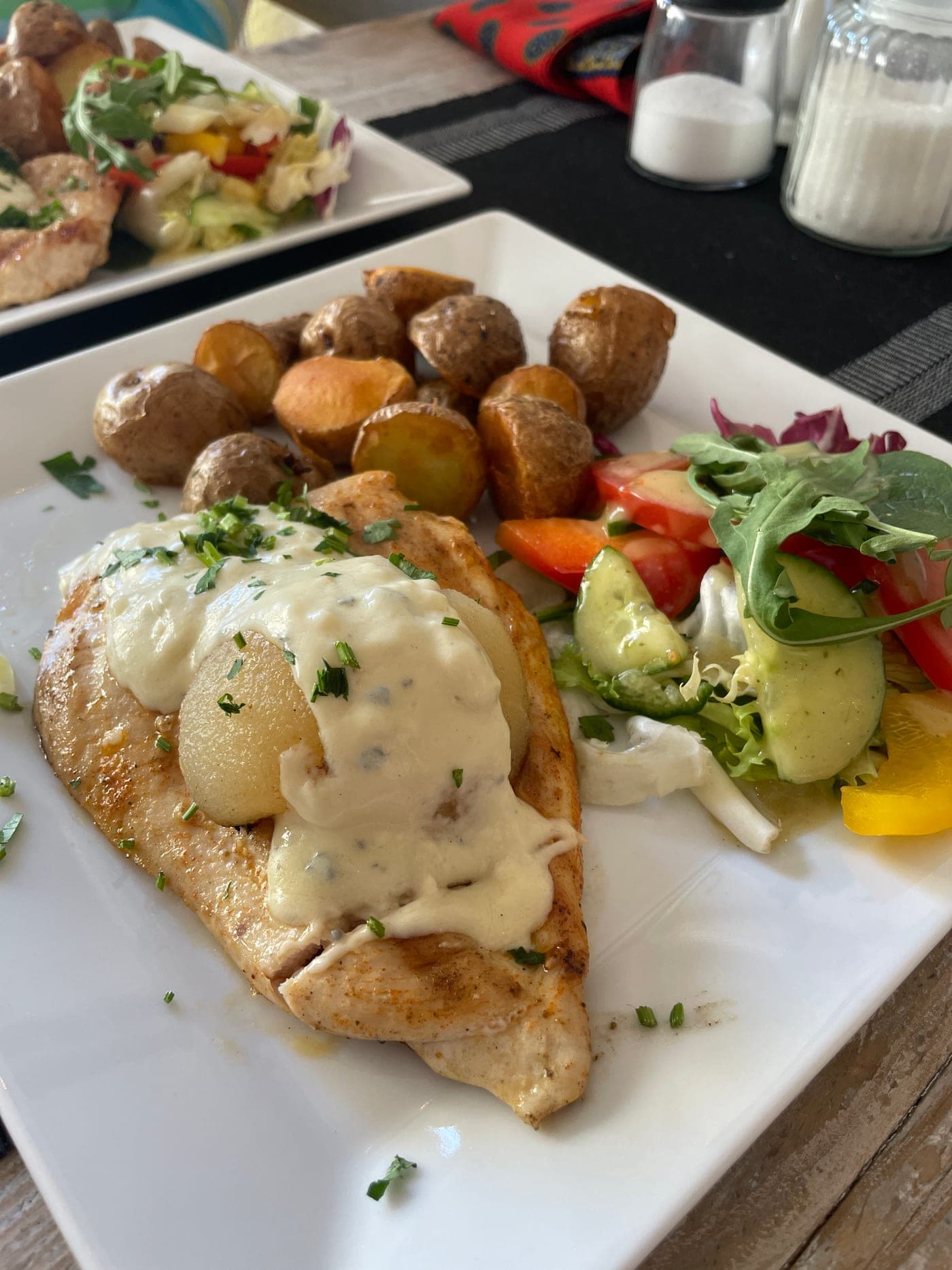 Grilled chicken with creamy sauce and salad on a Tasty Trails food tour
