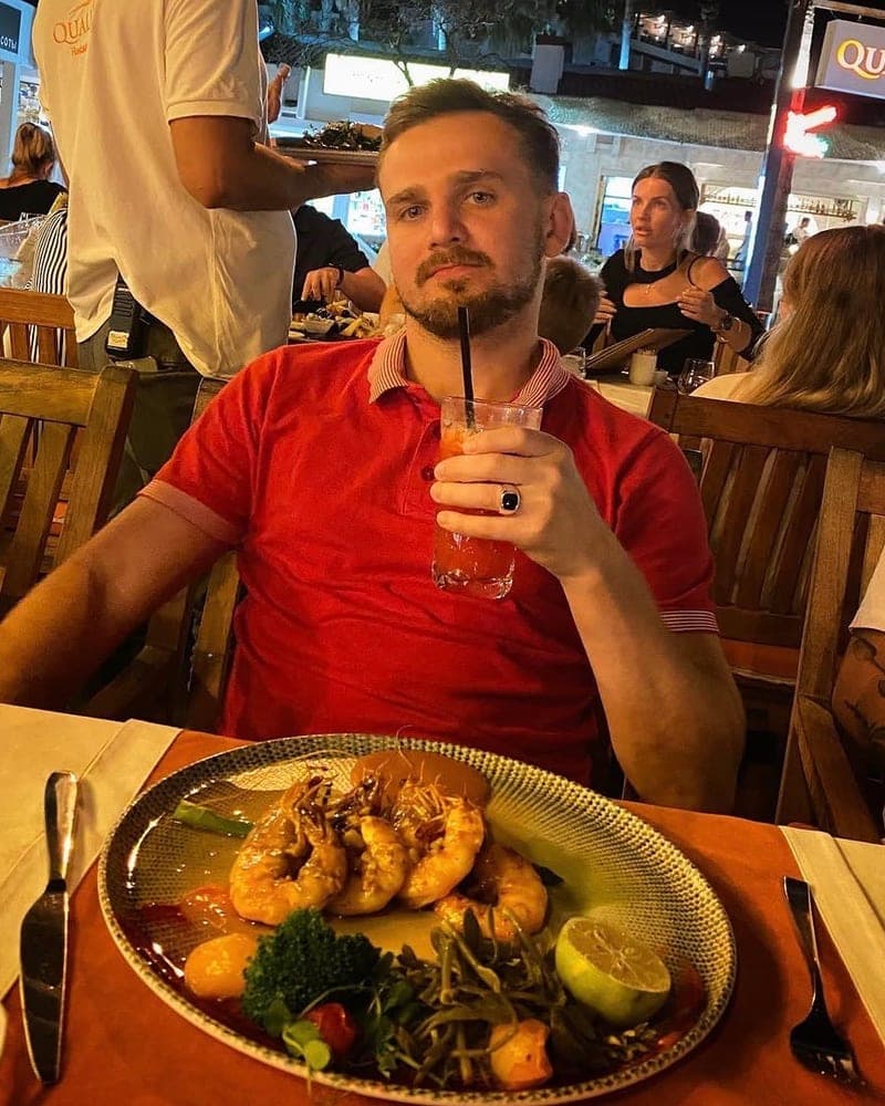 Patryk, Tasty Trails co-founder, at a restaurant table